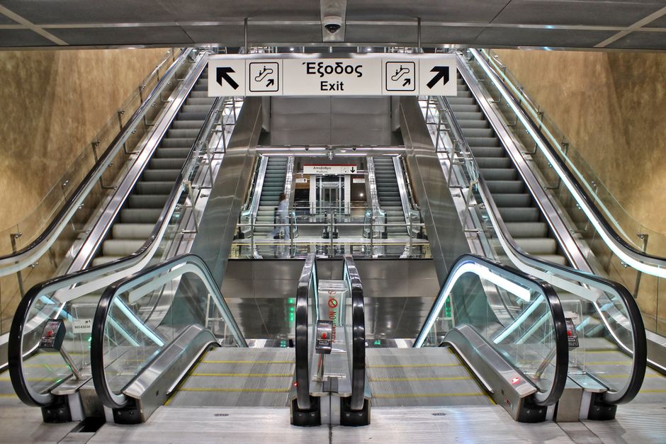 Modern Athens metro station with a train arriving, showcasing efficient public transport in Greece