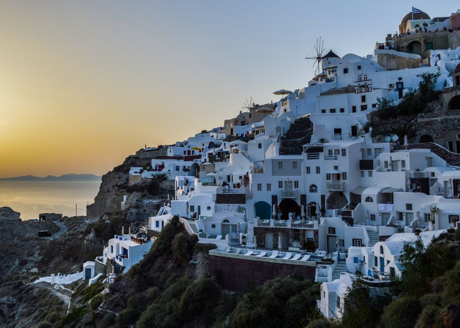 Iconic sunset view over the caldera in Santorini, Greece, with white-washed buildings