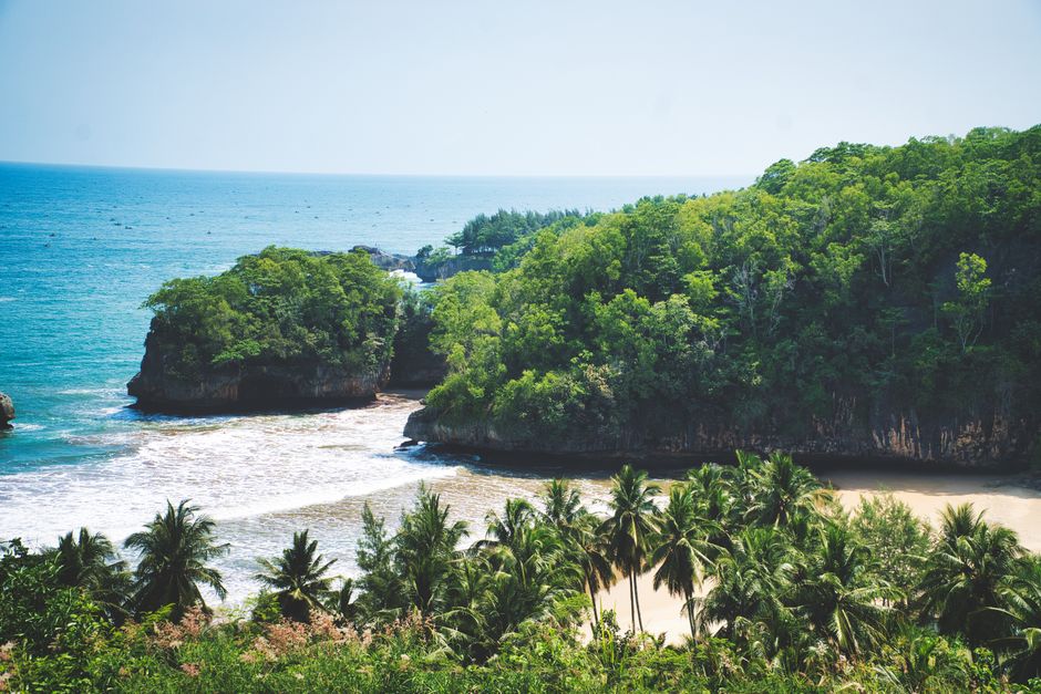 Sunny Kuta Beach in Bali, Indonesia during the dry season with clear blue skies