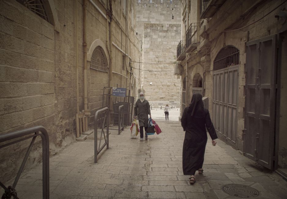 Vibrant market scene in Jerusalem's Old City, Israel, with local goods and people