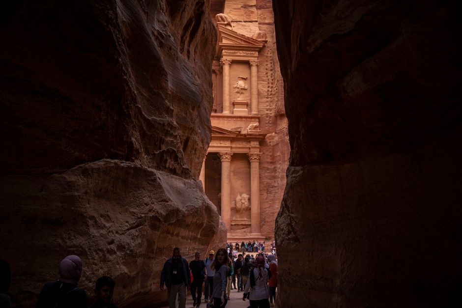 The iconic Treasury (Al-Khazneh) at Petra Archaeological Park in Jordan, bathed in golden sunset light