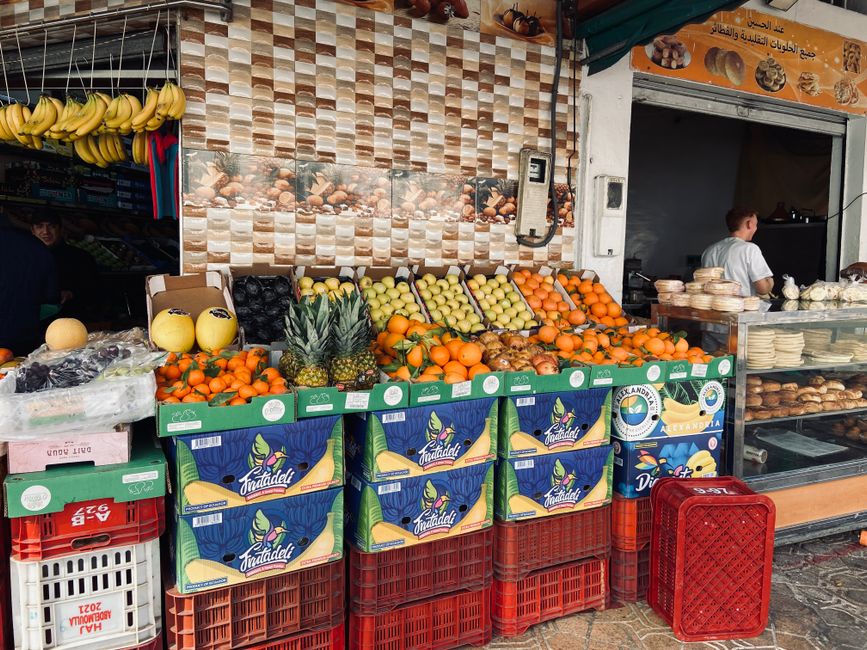 A vibrant street food stall in Amman, Jordan, selling falafel sandwiches