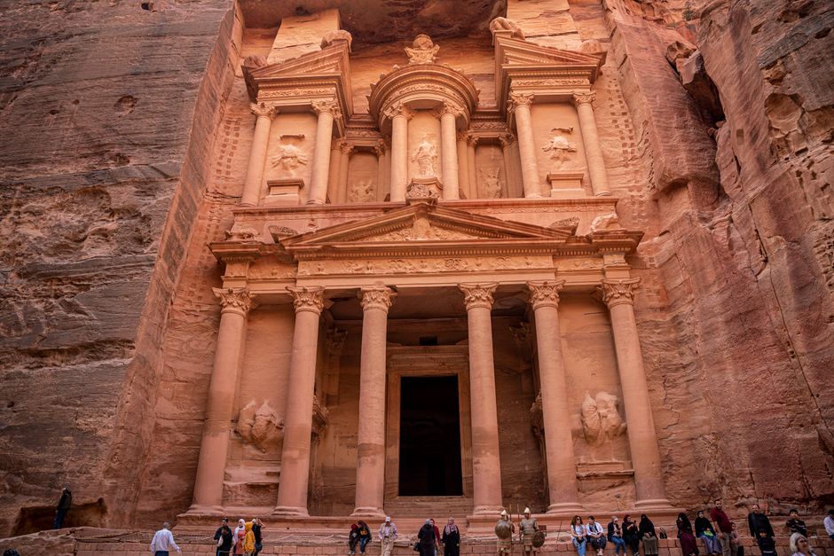 Traveler admiring the Treasury at Petra, Jordan, highlighting the importance of travel insurance for exploring ancient sites.