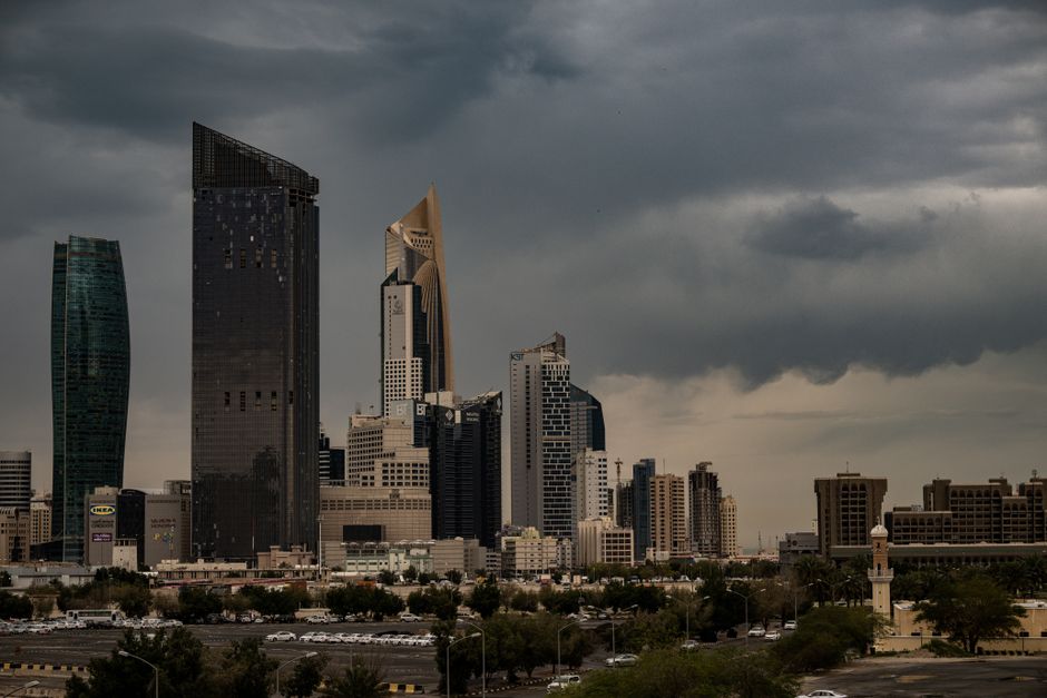 Panoramic view of Kuwait City skyline with modern skyscrapers at sunset, representing the Al Asimah Governorate