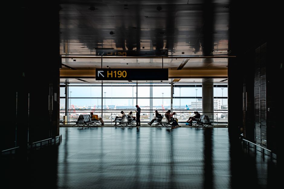 Travelers arriving at Kuwait International Airport, looking for transfers