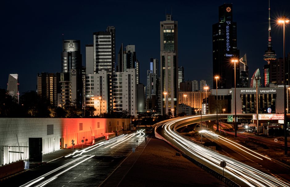 Modern skyscrapers of Kuwait City under a clear, sunny sky, showcasing typical Kuwait weather.