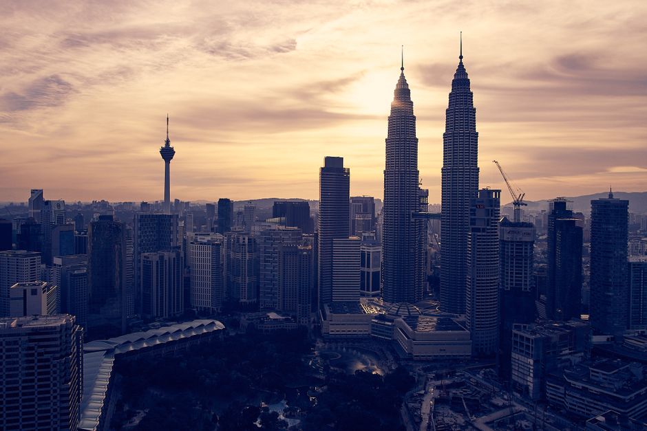 Panoramic view of Kuala Lumpur skyline at sunset with Petronas Towers in Malaysia