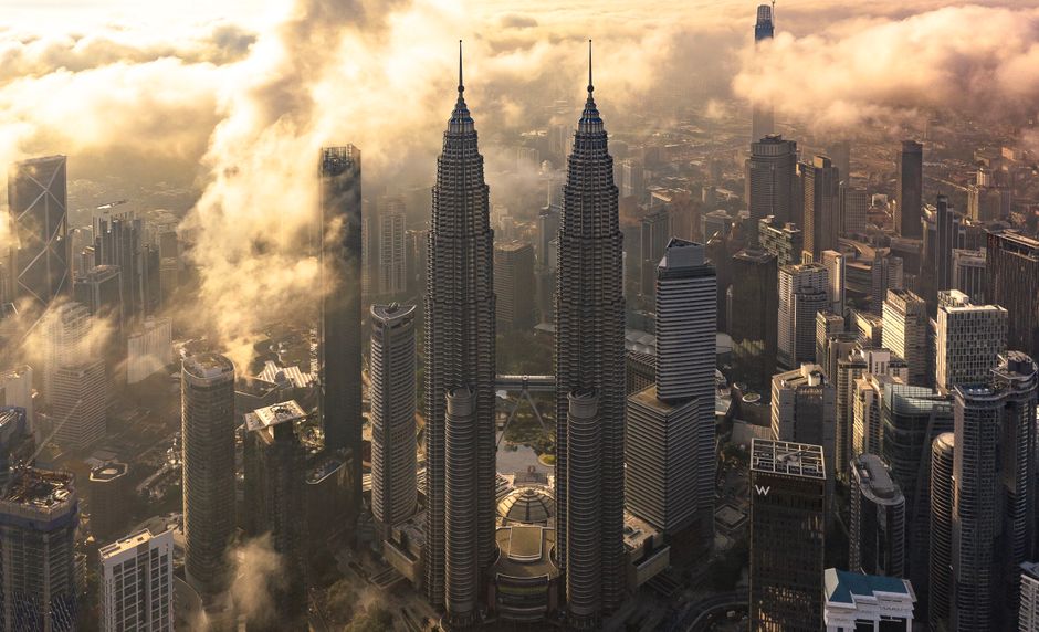 Kuala Lumpur skyline at sunset, showcasing the vibrant city lights and modern architecture of Malaysia