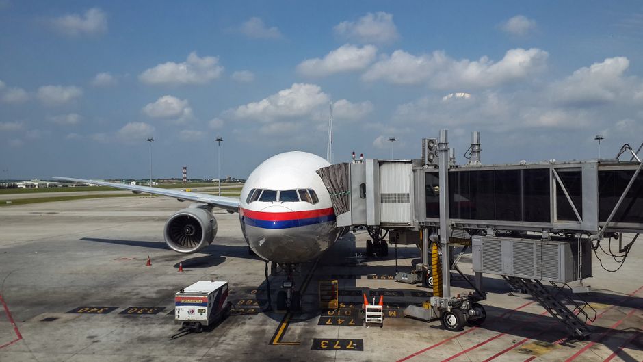 Modern terminal at Kuala Lumpur International Airport in Malaysia with planes visible