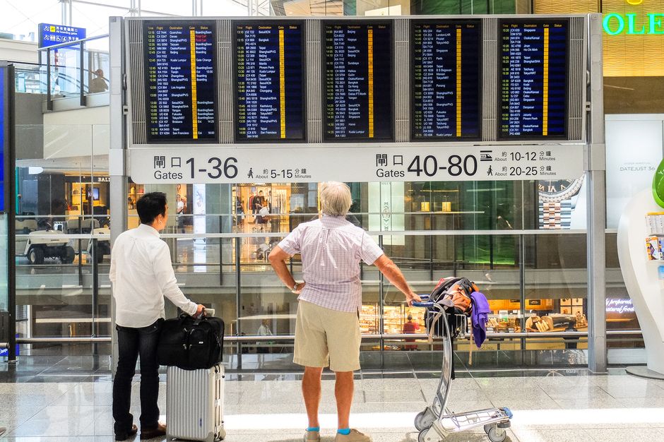 Departure board showing delayed flights at Malta International Airport