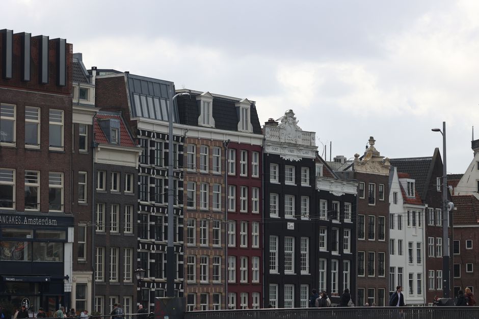 Picturesque canal houses lining a waterway in Amsterdam, Netherlands