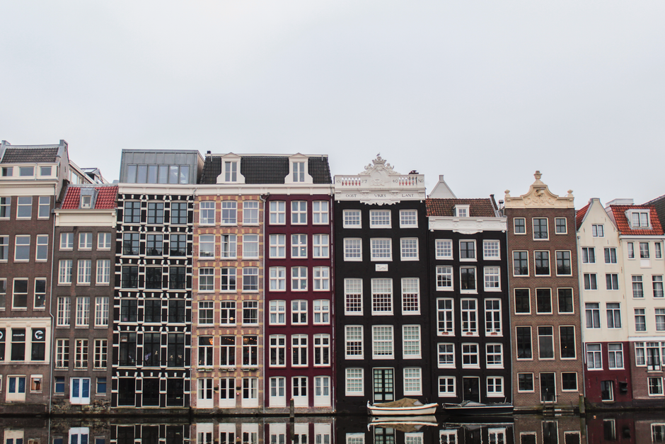 Picturesque canal in Amsterdam, Netherlands, with historic buildings and a boat