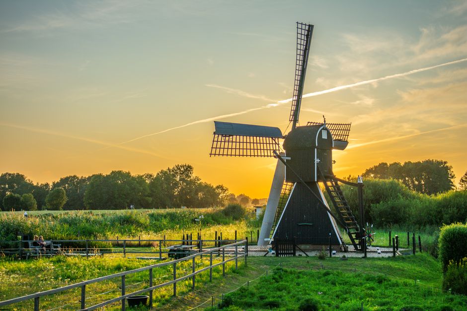 Scenic view of traditional Dutch countryside with windmills and canals in the Netherlands