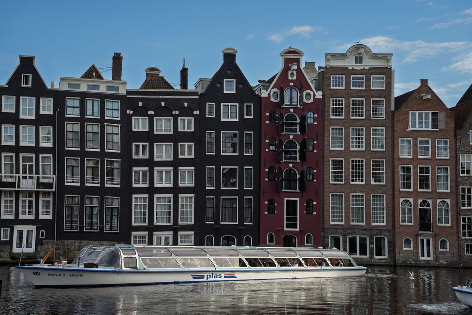 Tourist using a smartphone in a picturesque street in the Netherlands