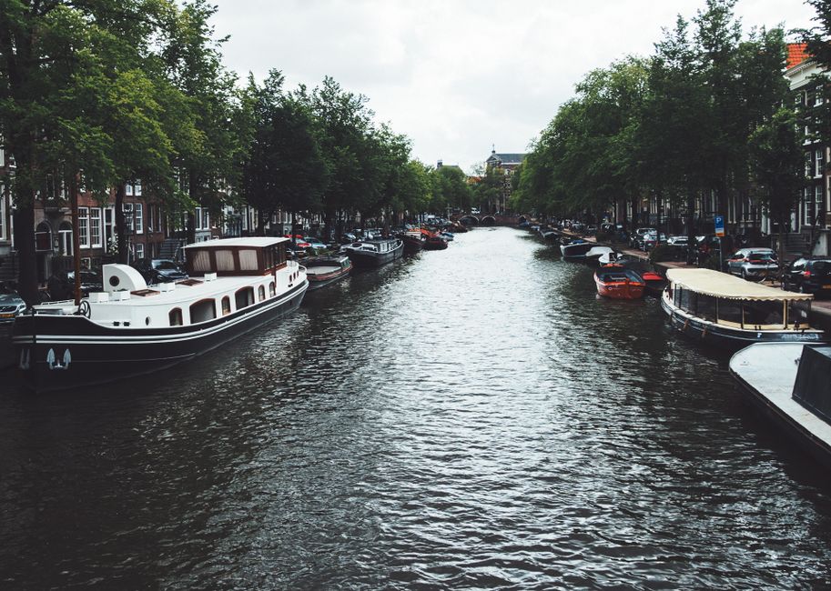 Scenic canal cruise boat navigating through historic Amsterdam, Netherlands