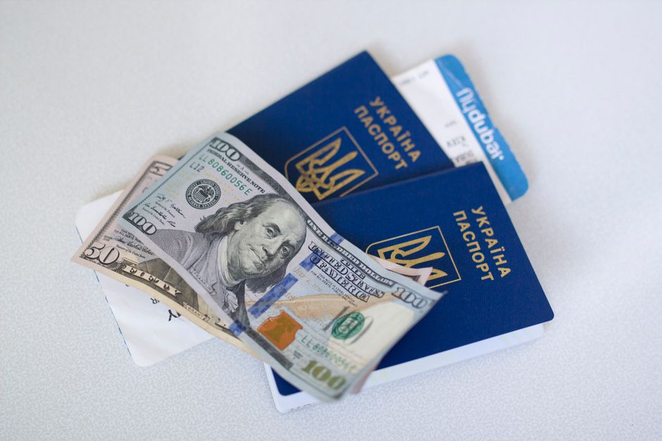 Travel insurance policy documents and a Dutch passport on a map of the Netherlands