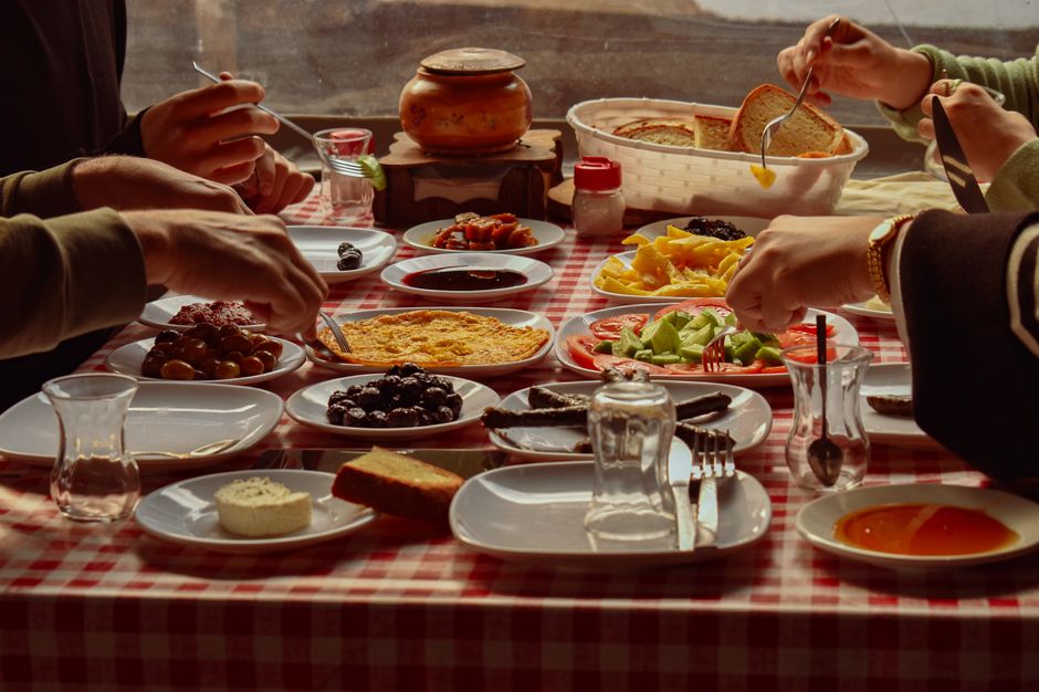 A vibrant spread of traditional Macedonian dishes like Tavče Gravče and Kebapi on a rustic table in North Macedonia