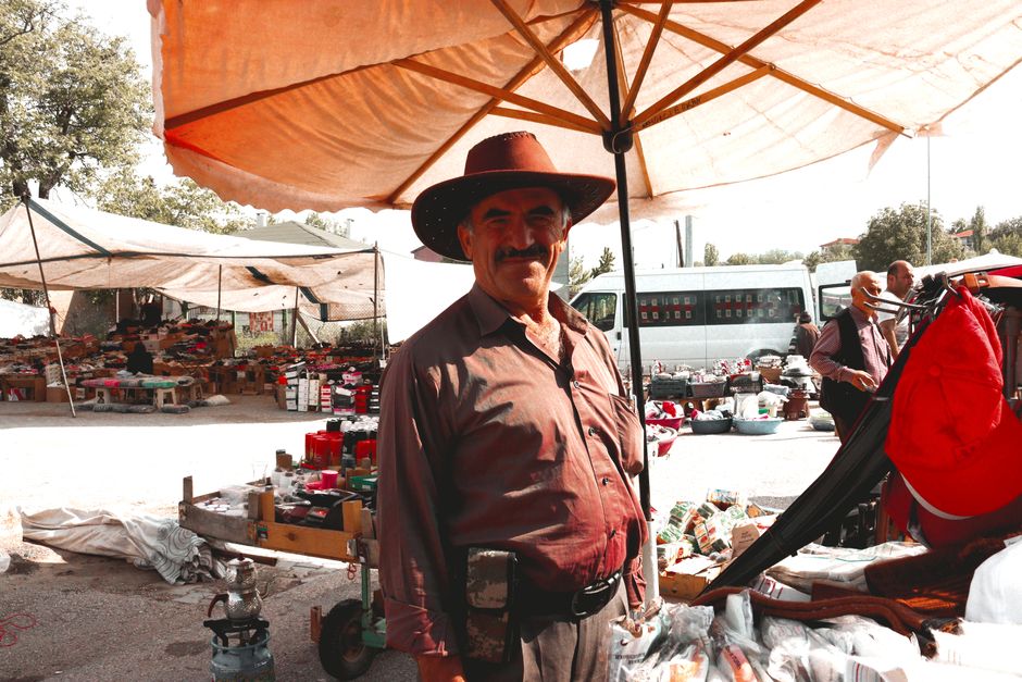 A bustling traditional market scene in North Macedonia with local vendors and shoppers