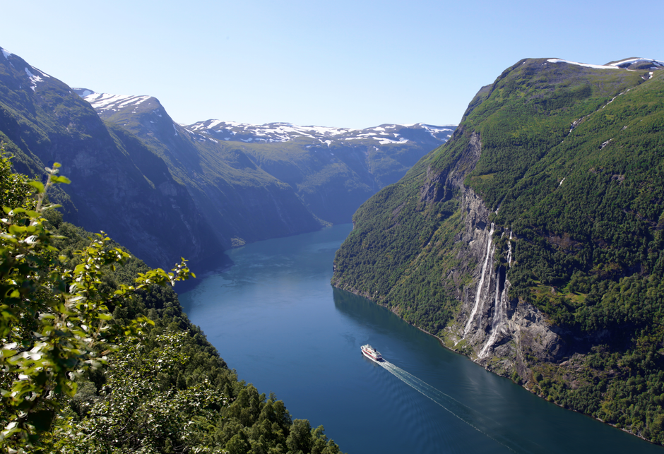 Stunning Norwegian fjord landscape with a map and Norwegian Krone, symbolizing travel planning and costs in Norway.