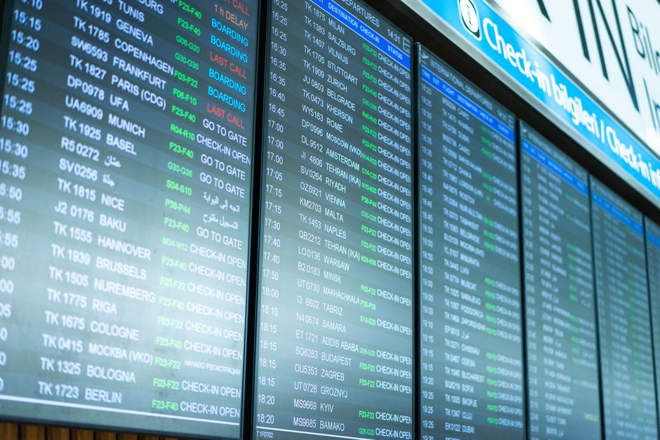 Departure board showing delayed flights at Oslo Gardermoen Airport, Norway