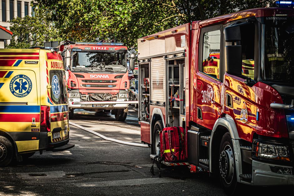 Emergency vehicle with lights on in a Norwegian city street