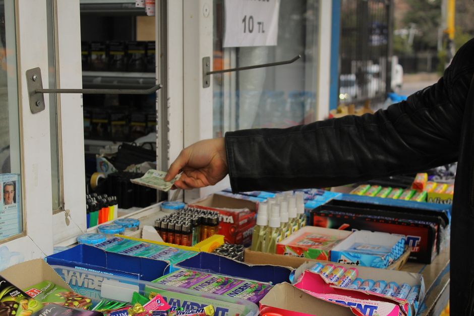 Tourist buying a prepaid SIM card in a kiosk in Oslo, Norway