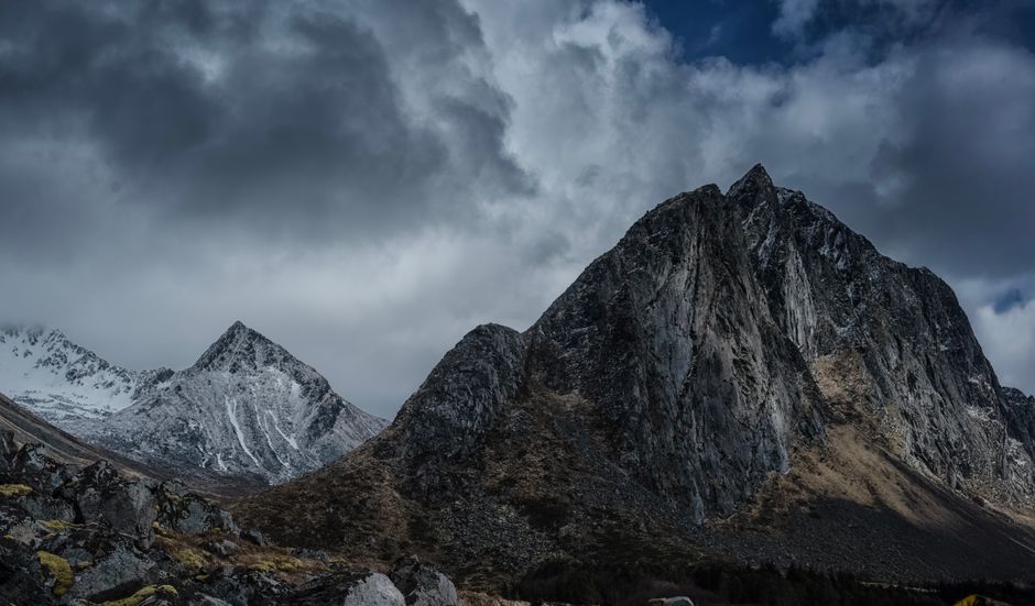 Dramatic Norwegian fjord landscape with changing weather conditions, showcasing mountains and water