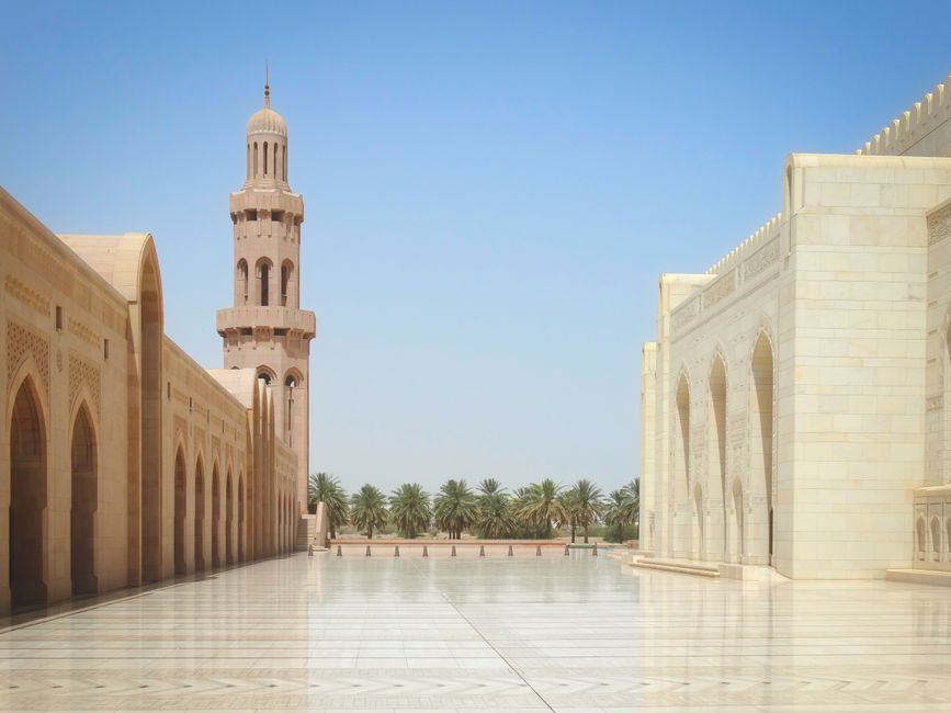 The majestic Sultan Qaboos Grand Mosque in Muscat, Oman, at sunrise, showcasing its stunning architecture