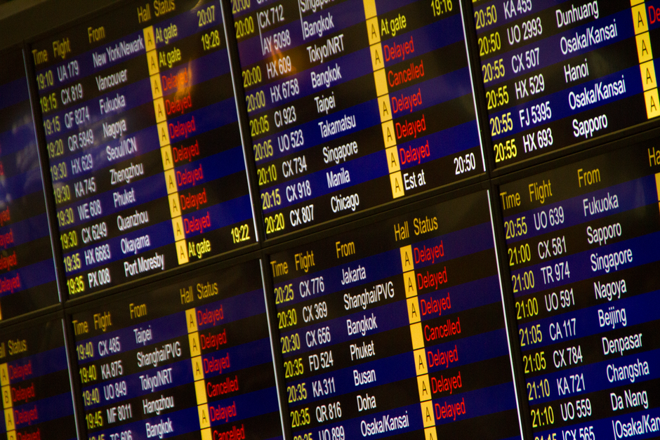 Departure board showing flight delays at Muscat International Airport, Oman