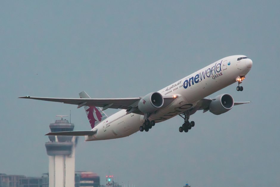 Departure board showing flight delays at Hamad International Airport in Qatar