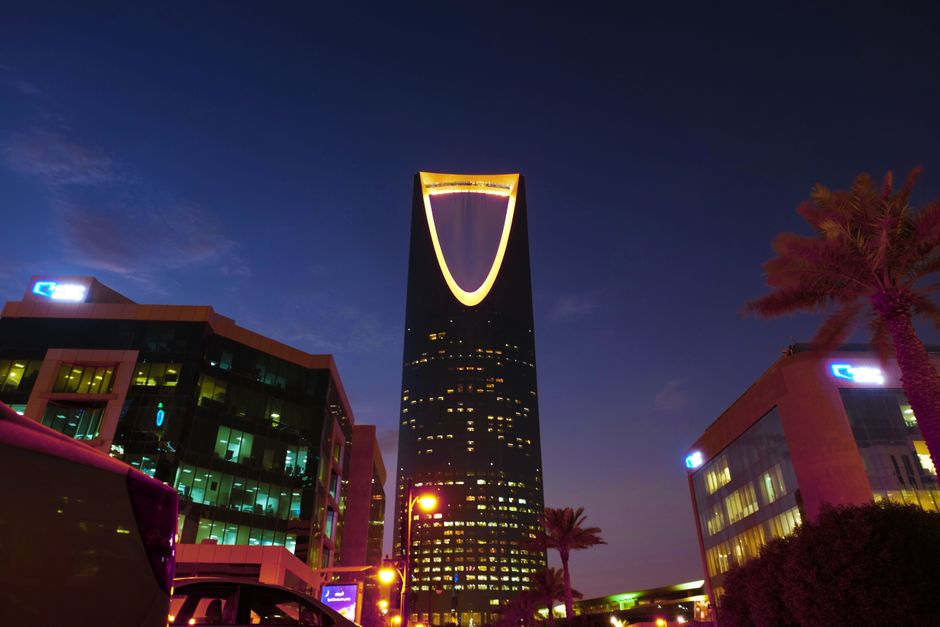A modern rental car parked at King Khalid International Airport in Saudi Arabia, ready for a road trip.