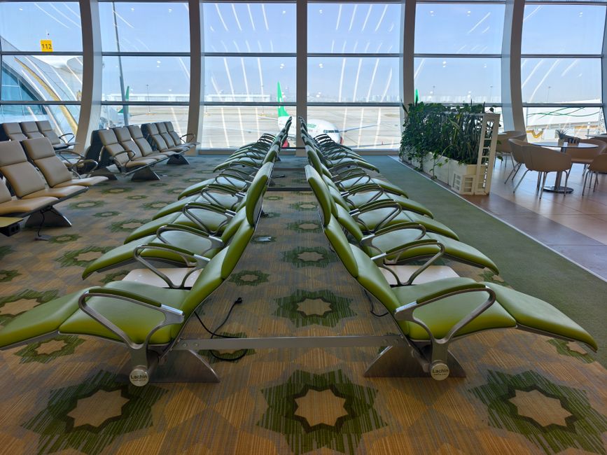 Modern terminal interior of King Khalid International Airport in Riyadh, Saudi Arabia, with natural light and sleek design.