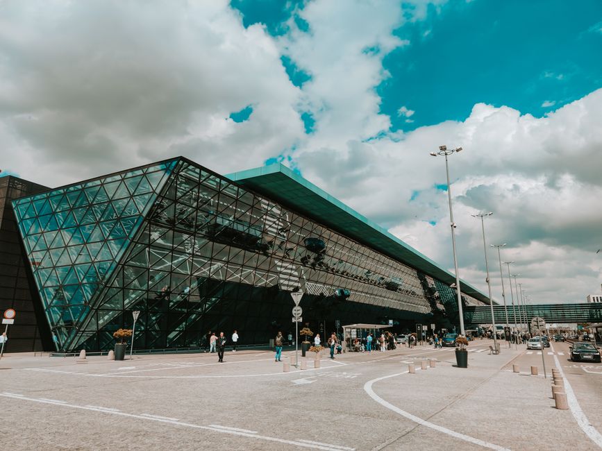 Travelers arriving at a modern airport terminal in Saudi Arabia, symbolizing safe travel with insurance.
