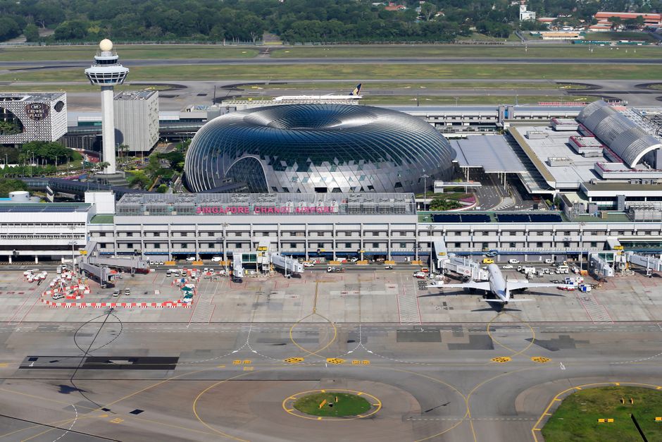 Modern departure lounge at Singapore Changi Airport with passengers