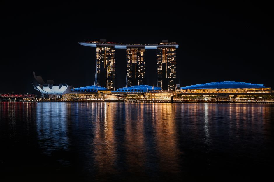Iconic Singapore city skyline with Marina Bay Sands hotel and Gardens by the Bay at sunset