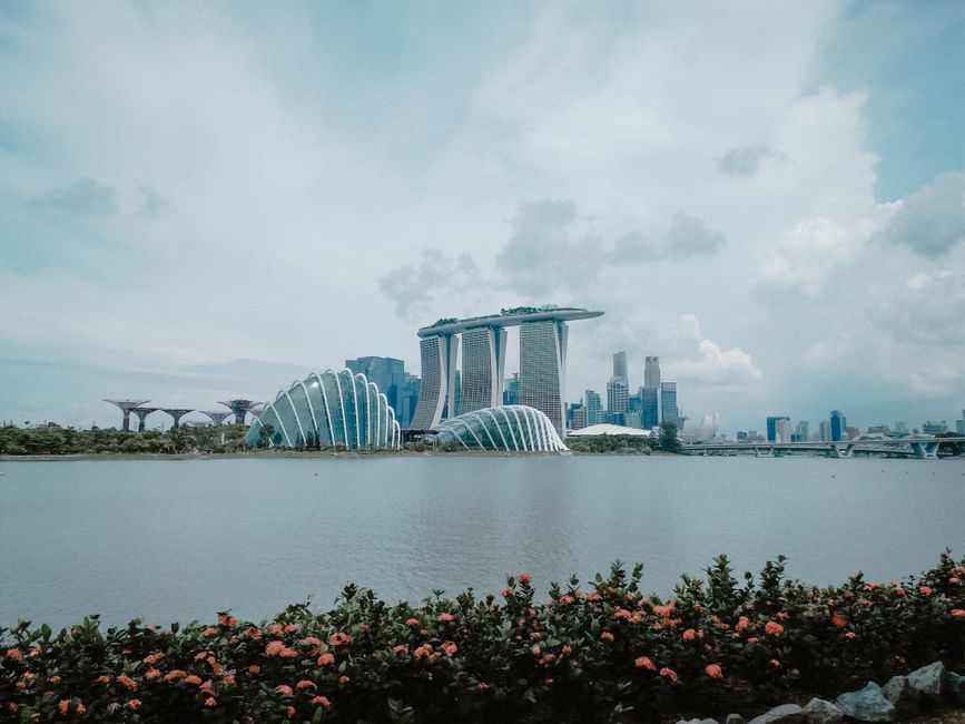 Singapore skyline with lush greenery and a light tropical rain shower