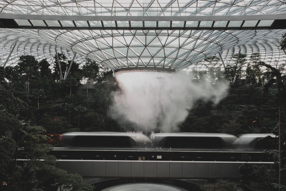Modern interior of Singapore Changi Airport terminal with travelers
