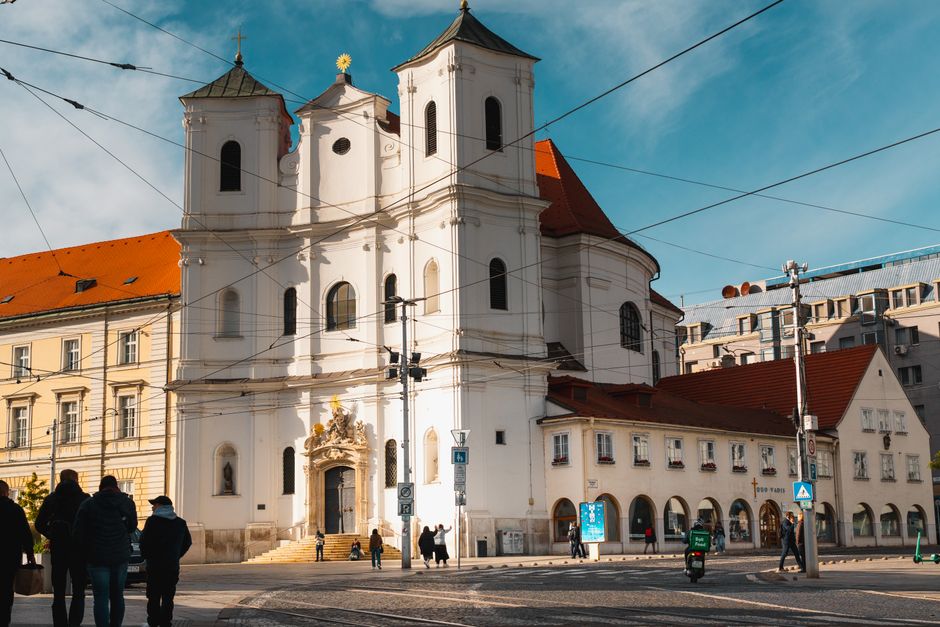 Traveler happily using a smartphone in a vibrant street in Bratislava, Slovakia