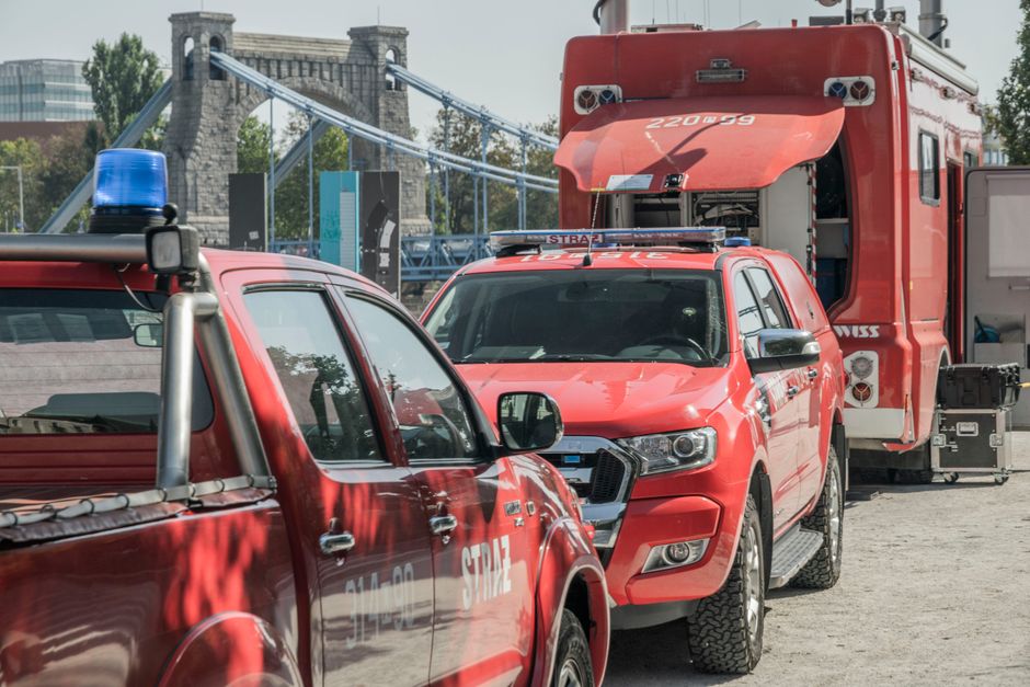 Emergency vehicle with flashing lights in a Slovakian city street, symbolizing safety.
