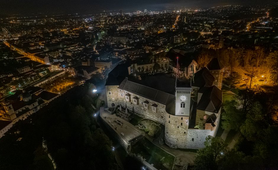 Panoramic view of Ljubljana, Slovenia, with historic buildings and the Ljubljanica River at sunset