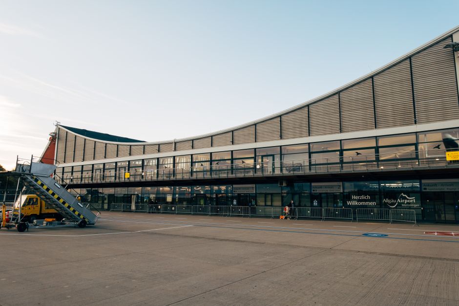 Exterior view of Ljubljana Jože Pučnik Airport terminal in Slovenia with mountains in the background