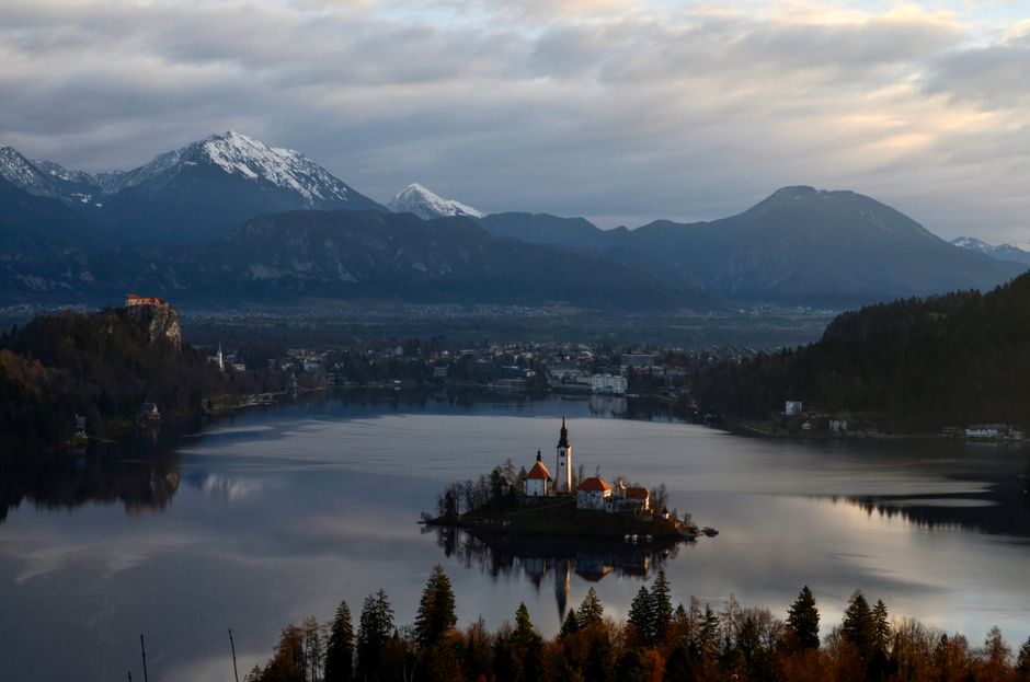 Iconic Lake Bled with island church and Julian Alps in Slovenia at sunrise