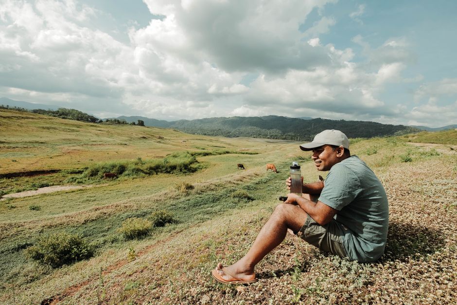 Traveler packing a backpack with essentials for a trip to Sri Lanka