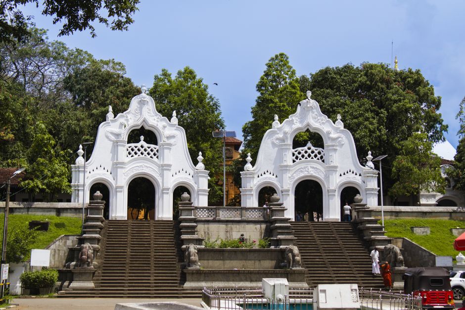 Tourist Police officer in Sri Lanka assisting a traveler near a temple