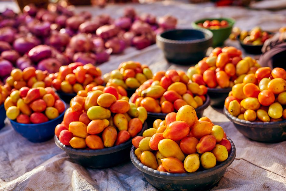 Colorful fresh produce and local Bahamian dishes at a market stall in Nassau, Bahamas