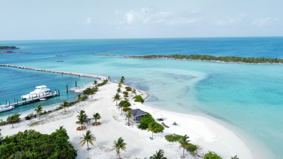 Couple relaxing on a pristine beach in the Bahamas, symbolizing a worry-free vacation with travel insurance