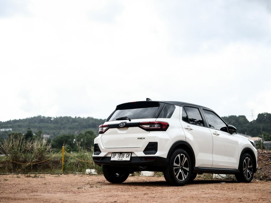 A Toyota Rush SUV on a rural road in Cambodia, symbolizing car rental freedom and adventure.