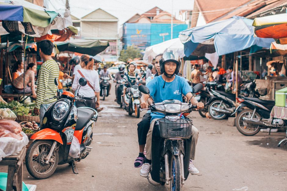 Vibrant night market in Cambodia with various street food stalls and people enjoying local cuisine