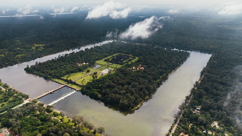 Panoramic view of Angkor Wat at sunrise in Cambodia, reflecting in the water