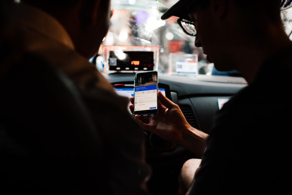 Tourist using a smartphone for navigation on a street in Cambodia